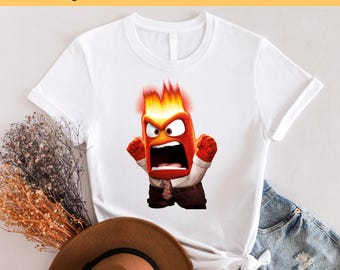 May include: White t-shirt with a cartoon image of a red and orange character with flames on his head. The character is yelling and has a surprised expression on his face. The text "Ready to Press DTF Transfer" is at the top of the image.