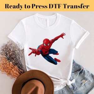May include: White t-shirt with a red and blue Spiderman graphic. The text "Ready to Press DTF Transfer" is at the top of the image.