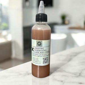 May include: A clear plastic bottle with a black cap and a white label. The label reads "UPROOTING GENERATIONAL CURSE BODY WASH." The liquid inside is a light brown colour. The bottle is on a white surface.