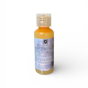May include: A small, clear bottle with a flip-top cap, filled with an orange liquid. The label reads "SPIRITUAL INTERNAL PURIFY CLEANSER" and includes usage instructions. The bottle is standing upright against a white background.