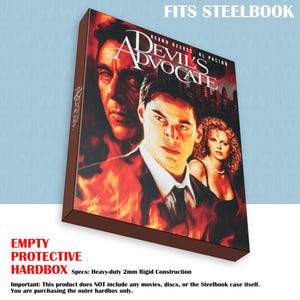 May include: Protective hardbox for a Steelbook case, featuring the movie "Devil's Advocate" with Keanu Reeves and Al Pacino. The box is brown with the movie title and actors' faces. The text "FITS STEELBOOK" is at the top.