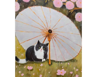 May include: A wall calendar featuring an oil painting of a black and white cat sitting under a large white paper umbrella. The scene is set in a field with pink flowers and cherry blossom branches overhead. The calendar has a black spiral binding.