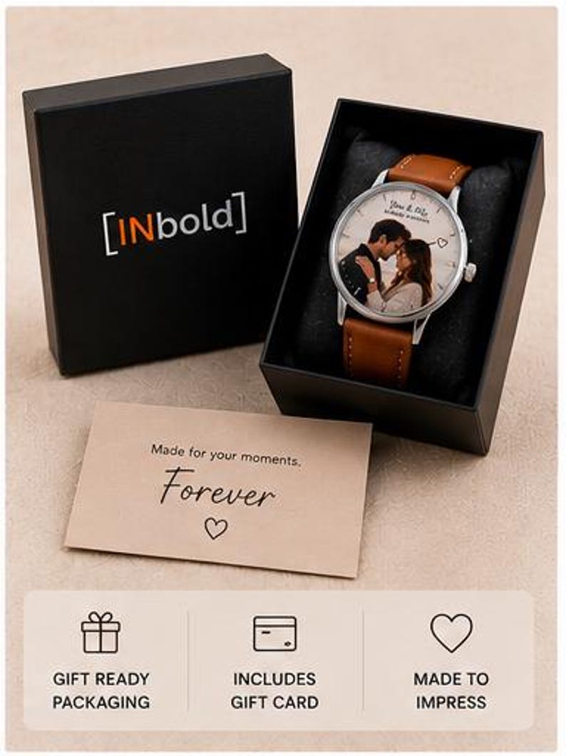 May include: A personalized watch with a brown leather strap and a silver-tone case. The watch face features a couple's photo and the words "Forever" and "Made for your moments" are printed on a card. The watch is presented in a black gift box.