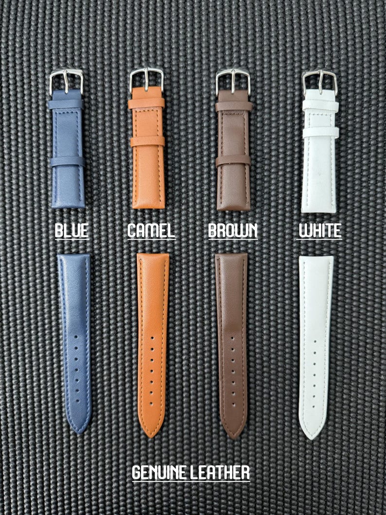 May include: An overhead shot displays four watch straps in blue, camel, brown, and white. Each strap is made of genuine leather and has a silver buckle. The word "BLUE", "CAMEL", "BROWN", and "WHITE" are printed below each strap. The words "GENUINE LEATHER" are printed at the bottom.