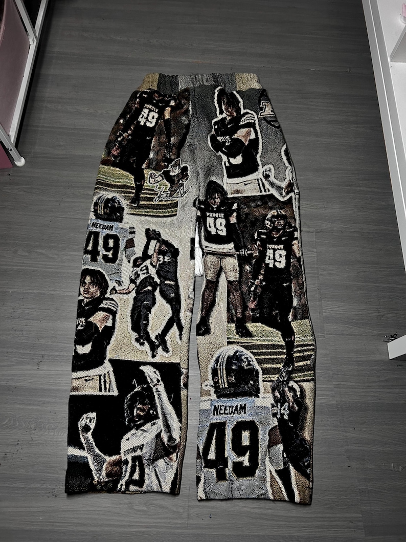 May include: Tapestry pants featuring a collage of football player images, including the number 49. The color palette includes black, white, gray, and tan. The pants are a unique, artistic piece.