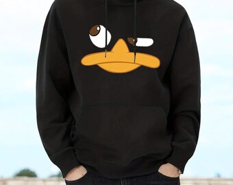May include: A black hooded sweatshirt featuring a graphic print of a cartoon platypus face with a large orange beak and two asymmetrical eyes. The hoodie includes a front kangaroo pocket, long sleeves, and black drawstring cords at the neck.