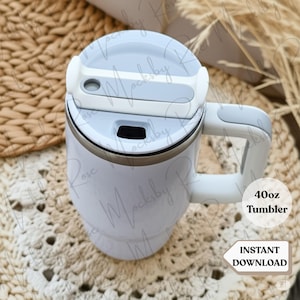 May include: A white 40oz tumbler with a light blue lid and handle. The tumbler has a silver rim and a black opening on the lid. The text "40oz Tumbler" and "Instant Download" are visible on the image.