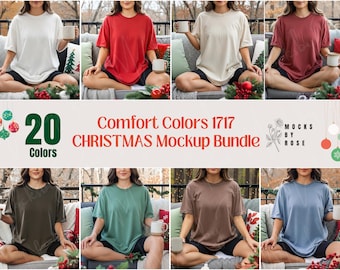 May include: A mockup bundle featuring 20 Comfort Colors t-shirts in various colors, including white, red, and green. The shirts are displayed on a model, with Christmas decorations in the background. Text on the image reads "Comfort Colors 1717 CHRISTMAS Mockup Bundle."