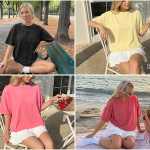 May include: Four short-sleeved t-shirts in black, butter, peony, and crimson. Each shirt is paired with a white skirt. The shirts are worn by a person in different outdoor settings. The word "BLACK", "BUTTER", "PEONY", and "CRIMSON" are written on the image.