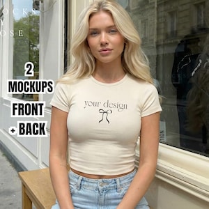 May include: A cream-colored, short-sleeved crop top with the text "your design" and a bow graphic. The model is wearing light blue jeans. The image also includes text that says "2 Mockups Front + Back".