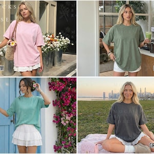 May include: Four different colored t-shirts are displayed. The colors are blossom pink, moss green, bay blue, and graphite gray. Each shirt has a crew neck and short sleeves. The shirts are worn with white skirts. The text "Mocks by Rose" is visible.