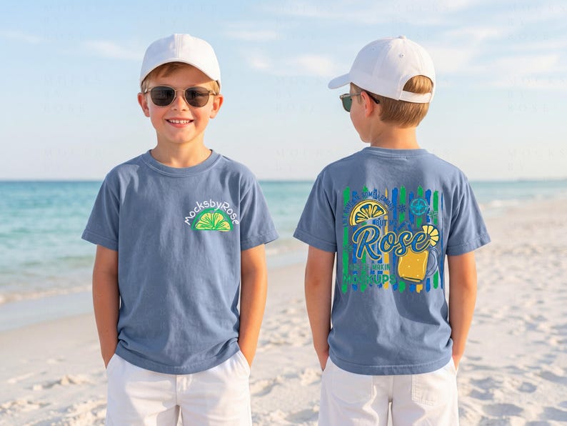 May include: Two children wearing blue t-shirts with a lime and lemon graphic. The front of the shirt has the text "mocksbyrose" and a lime graphic. The back of the shirt has a lemon and drink graphic with the text "Rose" and "Sip It Up".