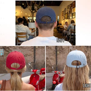 May include: A navy blue, red, and light blue baseball cap. Each cap has a curved brim and an adjustable metal buckle closure on the back. The word "NAVY", "RED", and "LIGHT BLUE" are written below each cap.
