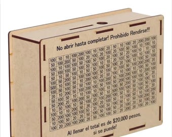 May include: A wooden savings box with the text "Set 4 Retos AHORRO" and a grid of numbers. The box has a slot on top and text that reads "No abrir hasta completar! Prohibido Rendirse!!!" and "Al llenar el total es de $20,000 pesos, si se puede!"
