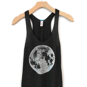 May include: A dark gray tank top with a white and gray moon graphic.