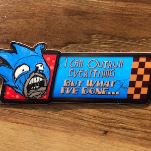 May include: A blue and red sticker with a cartoon character and the text "I can outrun everything but what I've done..."