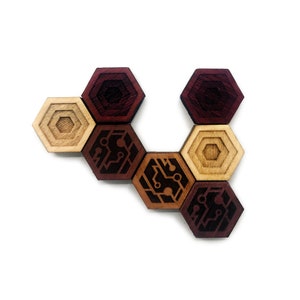 May include: A set of six hexagonal wooden tiles with a circuit board design. The tiles are arranged in a curved pattern. The tiles are in shades of brown and red.