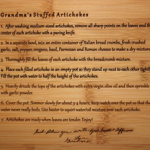 May include: A wooden cutting board with instructions for making Grandma's Stuffed Artichokes. The instructions are written in a handwritten font and include steps for preparing, filling, and cooking the artichokes.