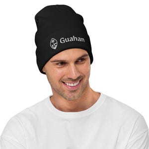 May include: Black beanie with a white embroidered logo that says "Guahan" and a small image of a palm tree.
