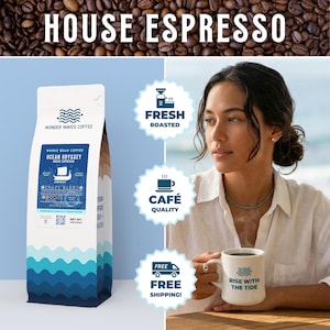 May include: A bag of Wonder Waves Coffee's Ocean Odyssey House Espresso, with the text "HOUSE ESPRESSO" above. The bag is white with blue wave graphics and text. A woman holds a mug that says "RISE WITH THE TIDE". The image also includes text that says "FRESH ROASTED", "CAFÉ QUALITY", and "FREE SHIPPING!"
