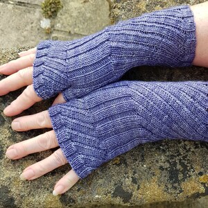 May include: A pair of purple fingerless gloves with a ribbed knit pattern.