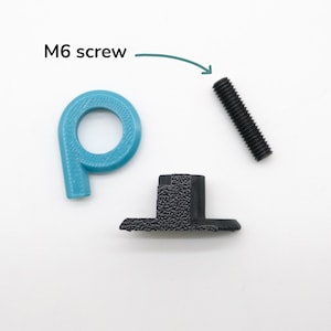 May include: An overhead shot shows three hardware components against a white background. A teal-coloured, P-shaped object, a black textured component, and a black M6 screw are visible. The text "M6 screw" is above the screw.
