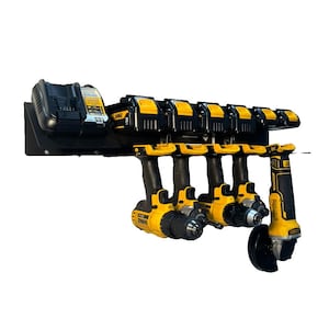 May include: A black wall-mounted power tool organizer holding several yellow and black power drills, batteries, and a charger. The tools are arranged neatly, showcasing a practical storage solution for a workshop or garage.