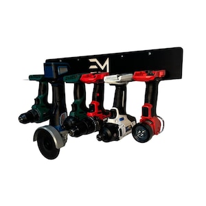May include: A black metal drill holder with the letters "EM" in white. The holder displays five power tools in various colors, including green, red, and white. The tools are arranged horizontally, showcasing their different designs and functions.