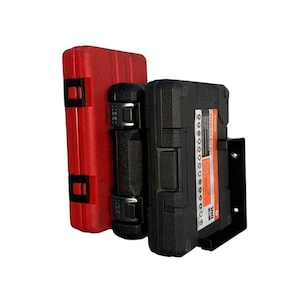 May include: A red tool case, a black ratchet, and a black tool case with an orange label are displayed. The tool cases are closed and have black latches. The black tool case on the right is mounted on a black metal bracket.
