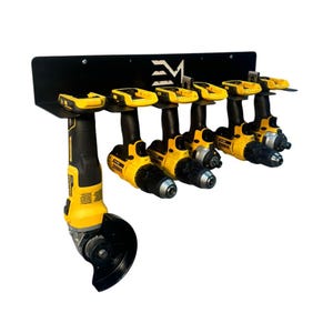 May include: Black metal wall-mounted storage rack with six yellow and black cordless drills and one yellow and black angle grinder hanging from it. The rack has the letters "EM" printed on it.