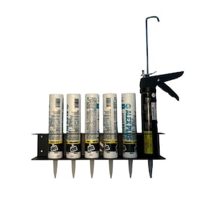 May include: A black metal caulk tube holder with six white and blue caulk tubes and a black caulk gun. The tubes are labeled "DAP" and "ALEX PLUS". The caulk gun has a silver hook.