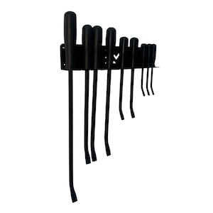 May include: A set of black pry bars of varying lengths, mounted on a black metal holder. The pry bars have rounded handles and curved ends, designed for leverage. The tools are arranged neatly, suggesting organization and readiness for use.