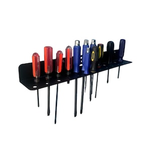 May include: A black metal screwdriver holder with multiple screwdrivers. The screwdrivers have red, blue, and black handles. The holder has a flat top with holes and vertical supports to hold the tools.