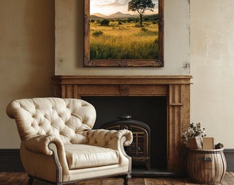 Op de afbeelding: Een witte leren fauteuil met knopenbekleding staat voor een open haard met een houtkachel. Boven de open haard hangt een ingelijst landschapsfoto van een savanne met een enkele boom.