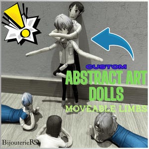 May include: Custom abstract art dolls with moveable limbs. The dolls are in various poses, with one doll embracing another. The text "CUSTOM ABSTRACT ART DOLLS MOVEABLE LIMBS" is visible. The dolls are on a wooden floor.
