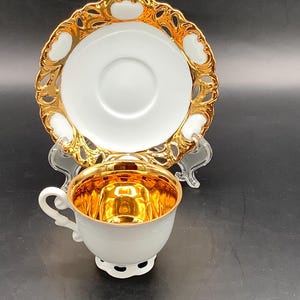 Japanese vintage gold and ivory colored, footed, teacup, and saucer