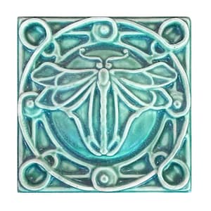 May include: Square ceramic tile with a dragonfly design in shades of teal and turquoise. The dragonfly is centered within a circular frame, surrounded by stylized floral and geometric patterns. The tile is approximately 4 inches square.