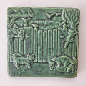 Dog with Raccoons Tile in Leaf Green Glaze. Made in Michigan, 4x4 inches.