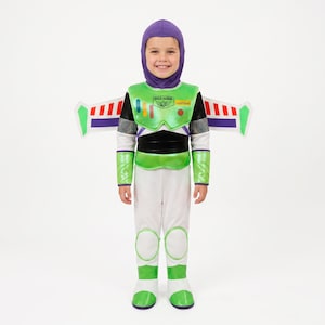 May include: A Buzz Lightyear costume featuring a purple hood, a white jumpsuit with green accents, and a chest plate with the text Space Ranger Lightyear. The outfit includes detachable wings with red, white, and blue stripes on a white background.