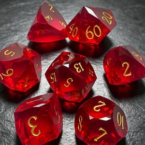 May include: A set of seven translucent red polyhedral dice with sharp edges and faceted surfaces. Each die features engraved numbers filled with gold-colored ink, including a d20, d12, d10, d8, d6, d4, and a percentile die, all arranged in a circular formation.