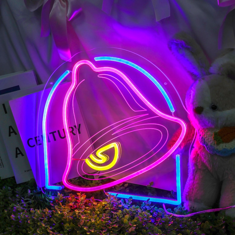 May include: A neon sign shaped like a bell with a pink outline and a blue outline. The bell is lit up with a yellow glow inside.