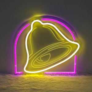 May include: A neon sign shaped like the Taco Bell logo. The bell is yellow and the outline is purple.