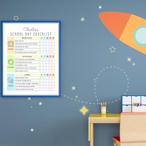 May include: A framed school day checklist titled Charlie's SCHOOL DAY CHECKLIST with sections for morning, afternoon, and evening tasks. The chart features icons for a clock, sun, and moon, with columns for days of the week and checkboxes.