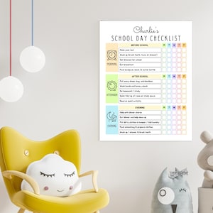 May include: A white rectangular wall poster titled Charlie's SCHOOL DAY CHECKLIST. The chart is divided into Morning, Afternoon, and Evening sections with icons for each, featuring daily task rows and columns for Monday through Friday.