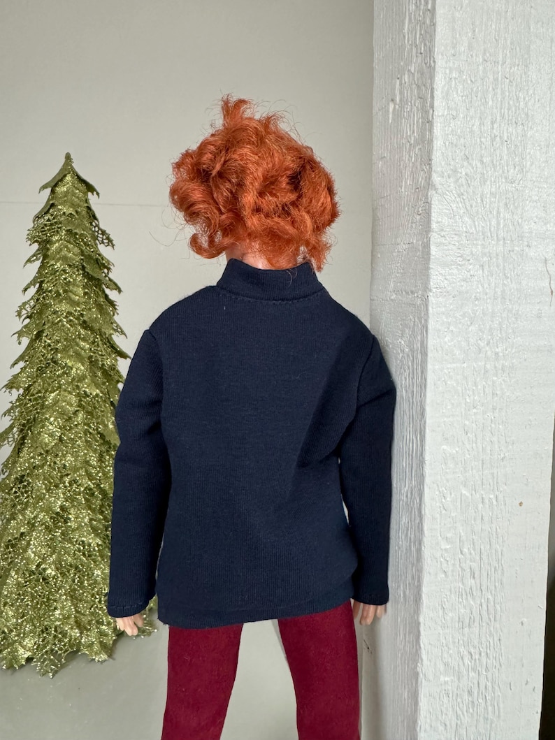 May include: A black long-sleeved shirt with a mock neck and red pants.