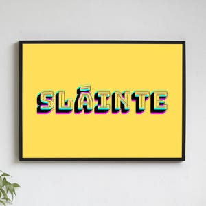 May include: A yellow background with the word "Sl&aacute;inte" in black, outlined in pink, blue, and yellow. The word is in a 3D style font.