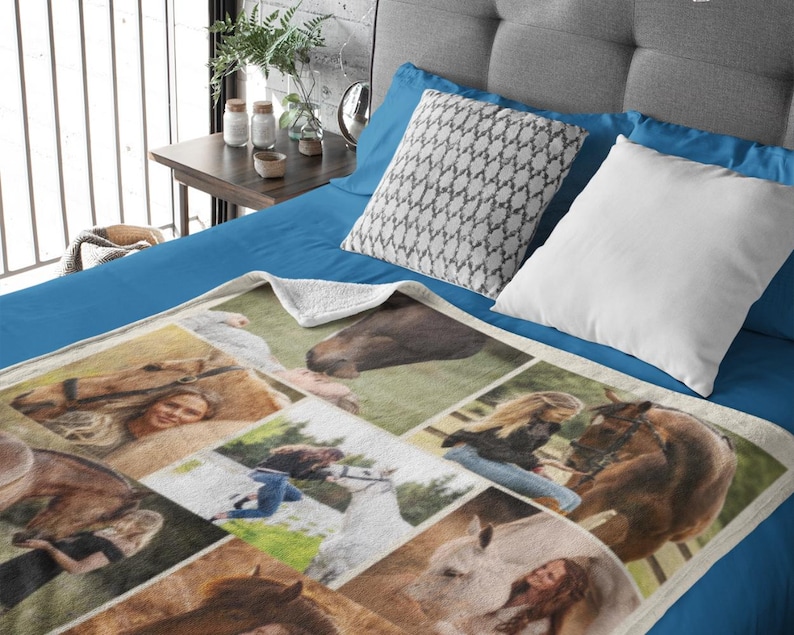 May include: A cream-coloured blanket with a collage of horse and people images. The blanket is on a blue bed, with white and patterned pillows. The images include close-ups of horses and people with horses. The blanket is soft.