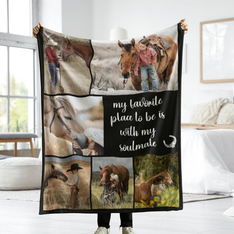 May include: A black and white blanket displaying several images of horses and people. The blanket has the text "my favourite place to be is with my soulmate" in white script. The blanket is being held up by a person.