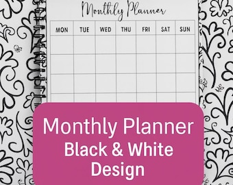 May include: A spiral-bound monthly planner with a black and white floral design. The planner has a white interior with a weekly layout and the days of the week labeled. The cover features the text "Monthly Planner Black & White Design" in white on a pink background.