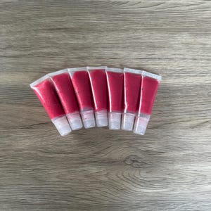 Affordable lip gloss, cherry lip gloss, shiny lip gloss, scented lip gloss, flavored lip gloss, moisturizing lip gloss, and pink lip gloss.